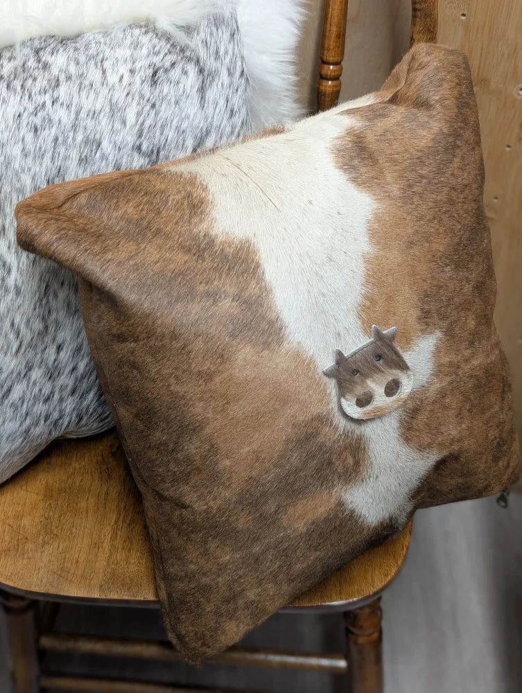 Mini moo brown and white cowhide cushion with stitched cow face design by angus oliver canada