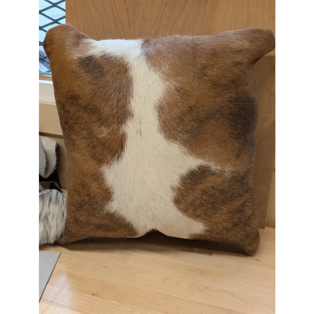 Brown and white mini moo cowhide pillow with natural fur texture by angus oliver canada perfect for cozy decor