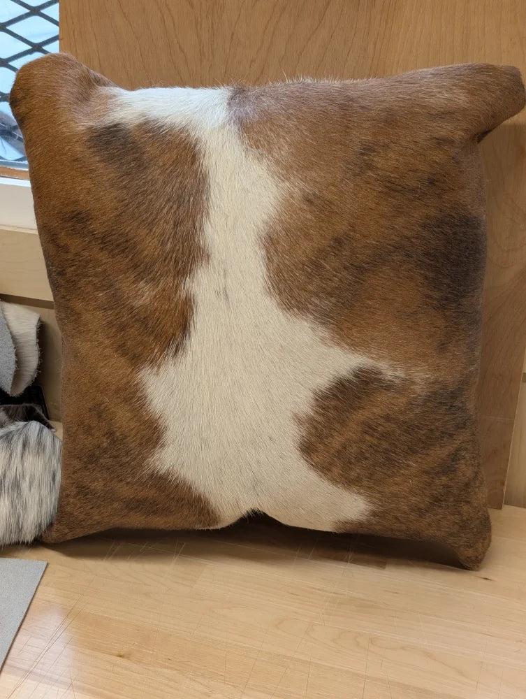Brown and white mini moo cowhide pillow with natural fur texture by angus oliver canada perfect for cozy decor