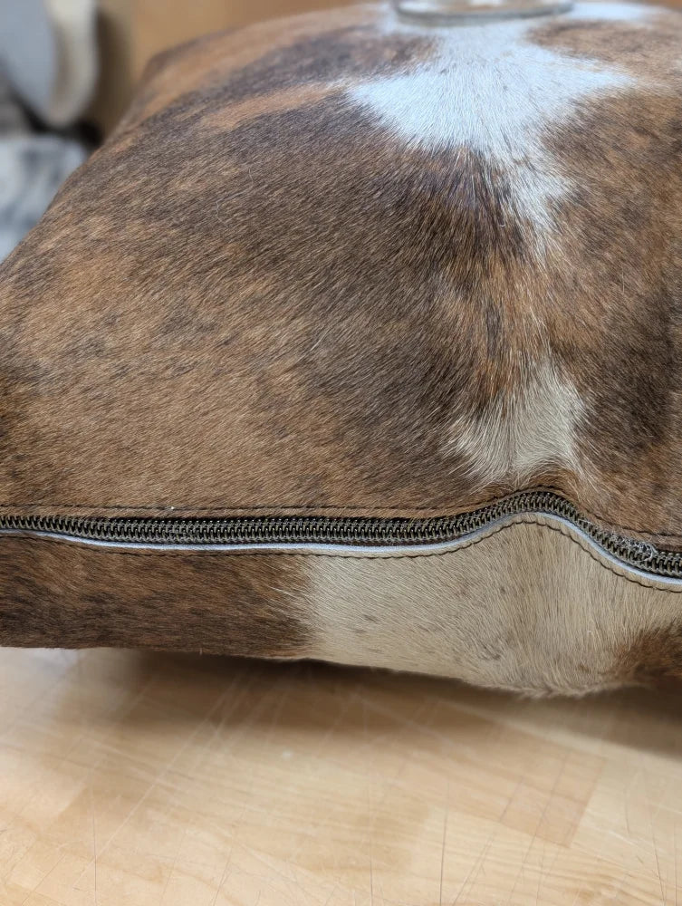 Brown and white cowhide mini moo cushion with visible zipper edge by angus oliver canada