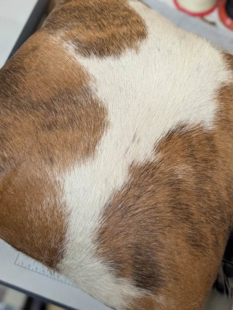 Brown and white mini moo double sided cowhide cushion with natural fur texture by angus oliver canada