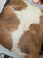 Brown and white mini moo double sided cowhide cushion with natural fur texture by angus oliver canada