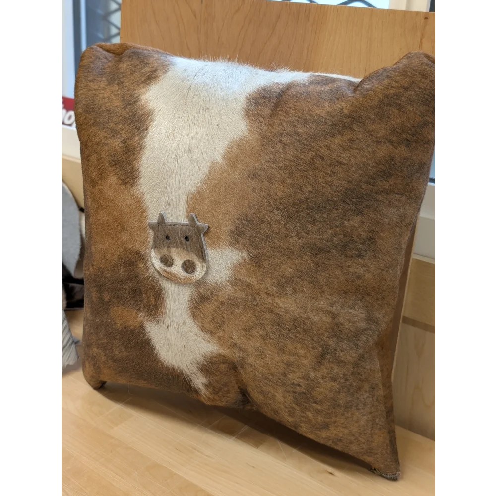 Brown and white cowhide mini moo cushion with stitched cow face appliqué by angus oliver canada