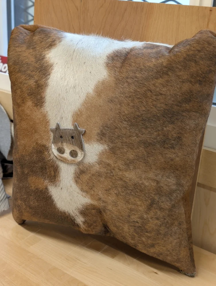 Brown and white cowhide mini moo cushion with stitched cow face appliqué by angus oliver canada