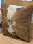 Brown and white cowhide mini moo cushion with stitched cow face appliqué by angus oliver canada