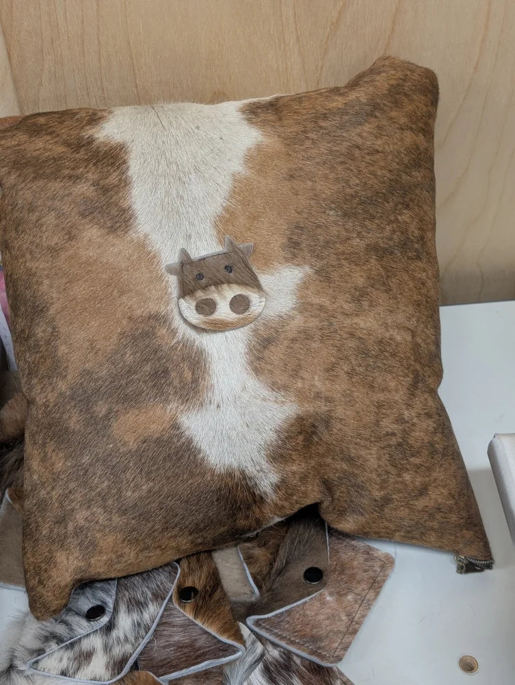 Brown and white cowhide mini moo cushion with stitched-on cow face design by angus oliver canada