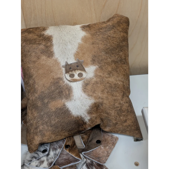 Brown and white cowhide mini moo cushion with stitched-on cow face design by angus oliver canada