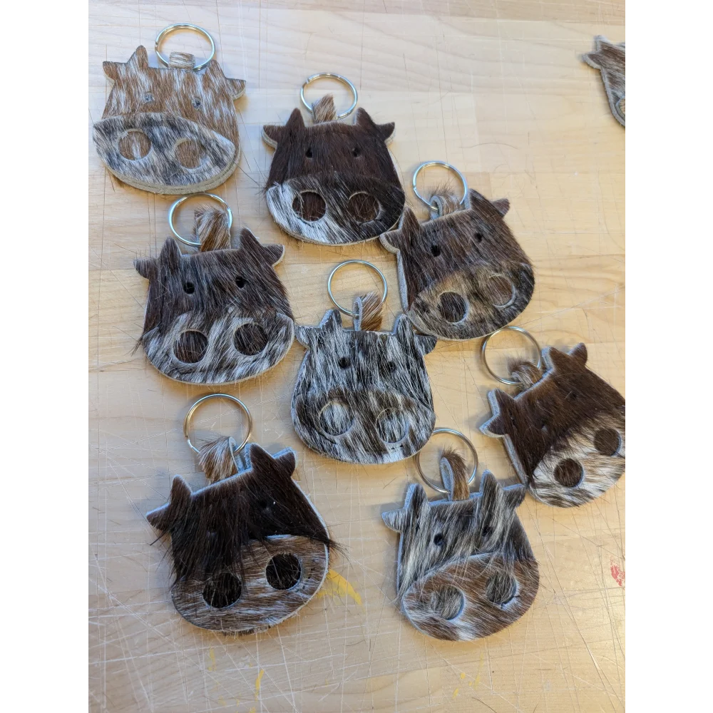 Mini moo cowhide keychain with natural brown and white patterns stitched eyes and metal ring by angus oliver canada