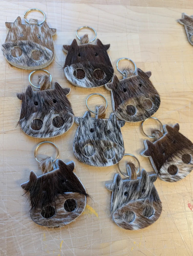Mini moo cowhide keychain with natural brown and white patterns stitched eyes and metal ring by angus oliver canada