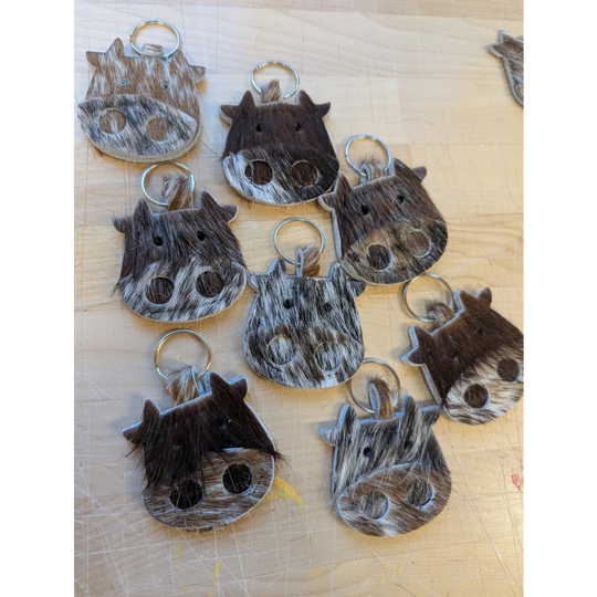 Mini moo cowhide keychain with natural brown and white patterns stitched eyes and metal ring by angus oliver canada