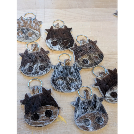 Mini moo cowhide keychain by angus oliver canada with black and white spots stitched eyes and metal ring
