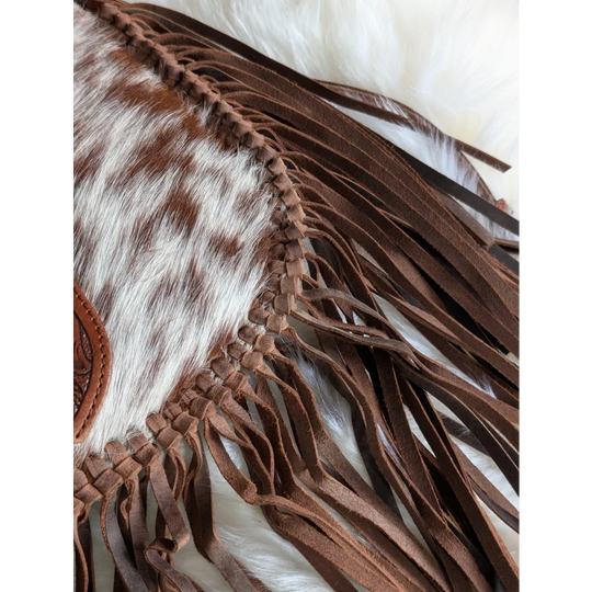 Mojave tassel bag with brown hunter leather fringe on speckled cowhide panel