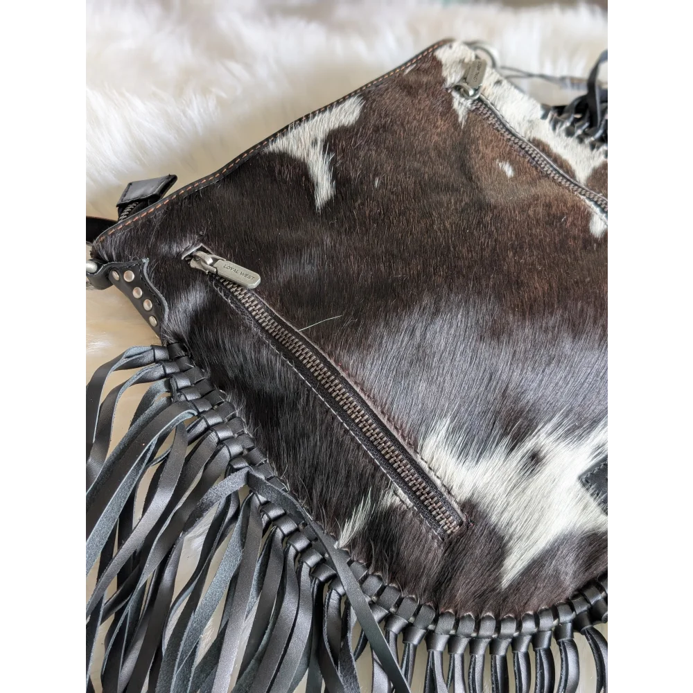 Mojave tassel bag in dark brown and white cowhide with hunter leather fringe