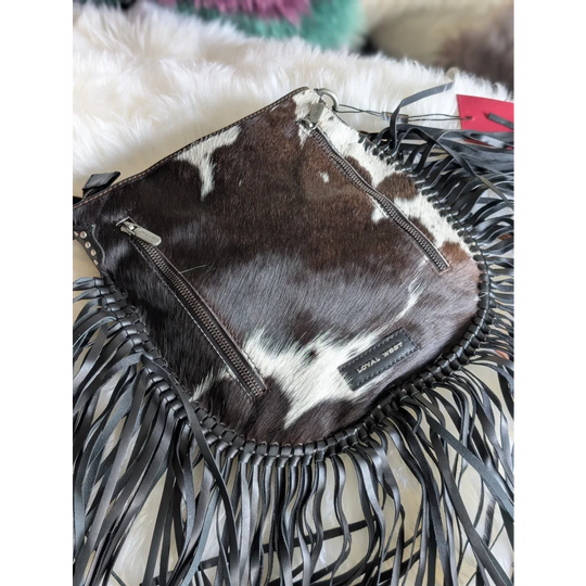 Mojave tassel bag in dark brown and white cowhide with fringe and hunter leather trim