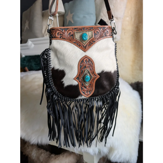 Mojave tassel bag in dark brown white cowhide with hunter leather tooling