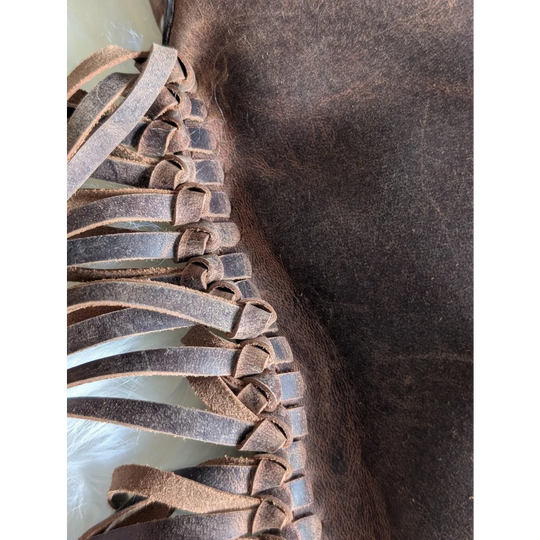 Brown leather braided strap detail on Mojave tassel bag