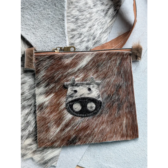 Brown and white cowhide coin purse with black stitched cow face appliqué by angus oliver canada