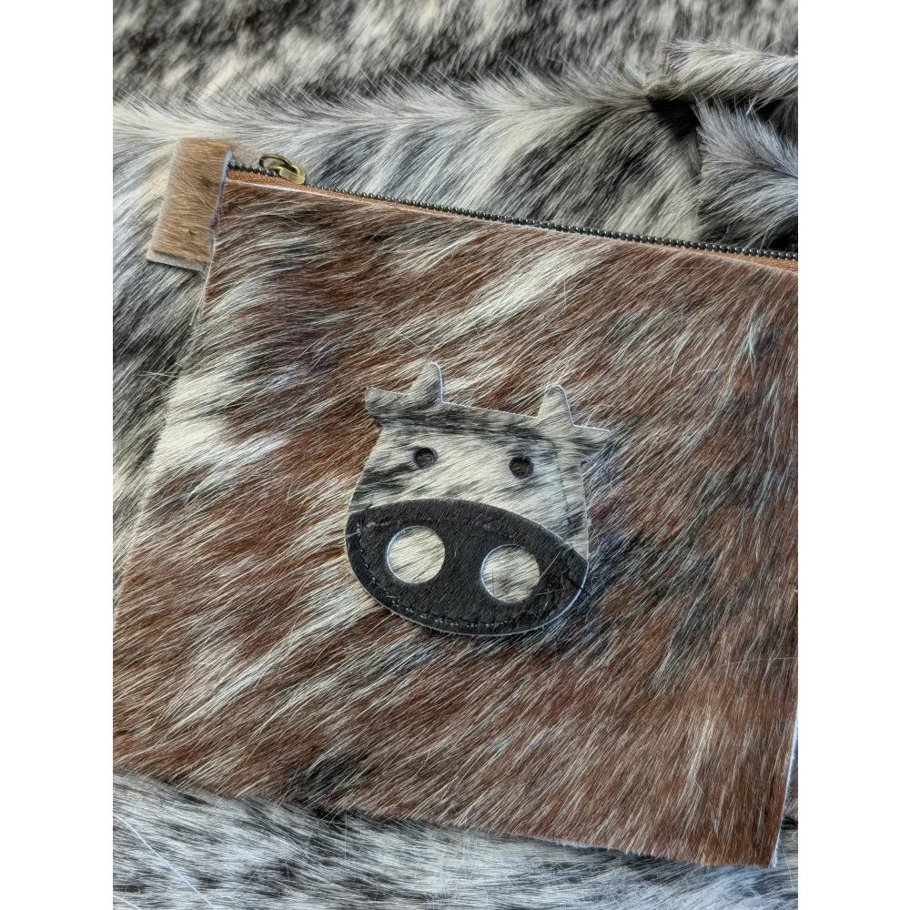 Brown and white cowhide coin purse with black leather angus oliver cow face appliqué made in canada