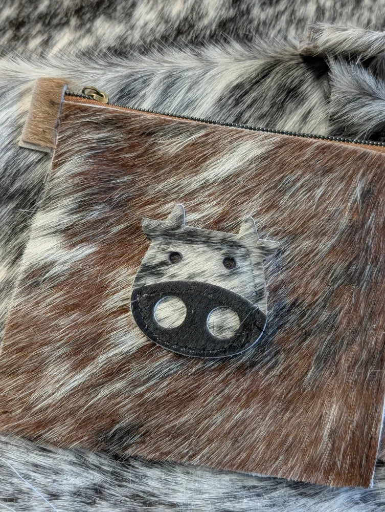 Brown and white cowhide coin purse with black leather angus oliver cow face appliqué made in canada