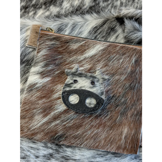 Brown and white cowhide coin purse with black leather angus oliver cow face appliqué made in canada