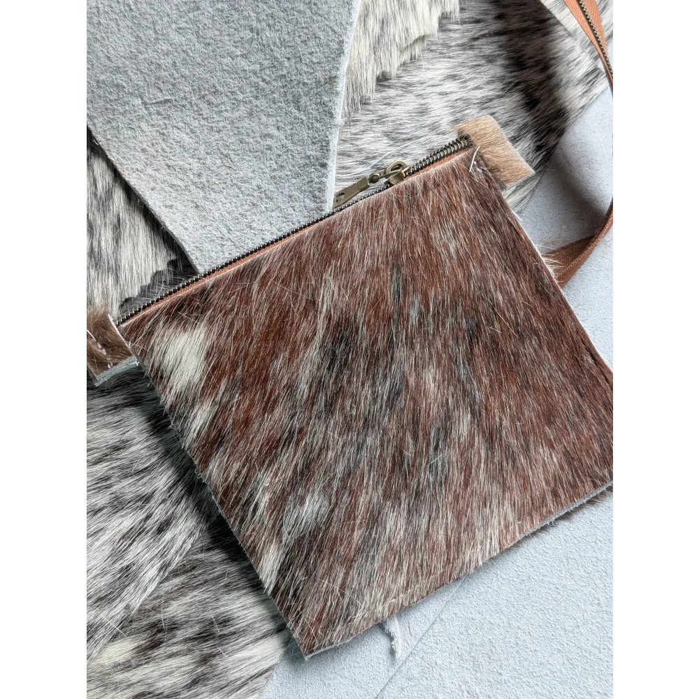 Rectangular brown and white cowhide coin purse with zipper closure by angus oliver canada perfect for coins