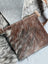 Rectangular brown and white cowhide coin purse with zipper closure by angus oliver canada perfect for coins