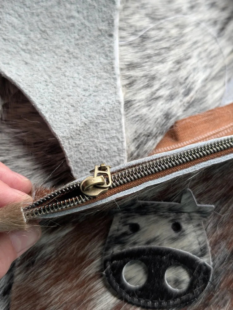 Gray and brown cowhide coin purse with brass zipper pull from angus oliver canada called moo coin purse
