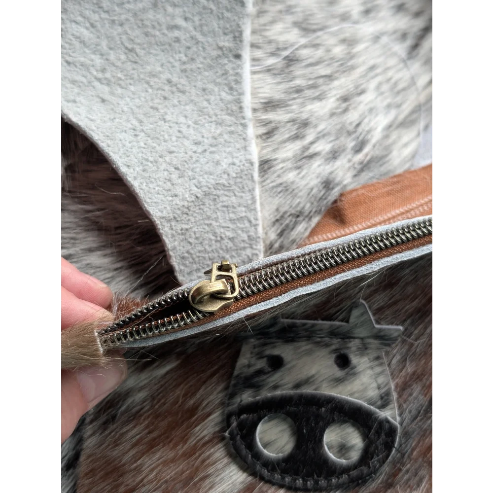 Gray and brown cowhide coin purse with brass zipper pull from angus oliver canada called moo coin purse