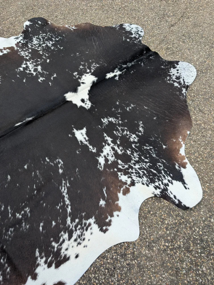 Large cowhide rug moon1 with black white and natural brown patches showing unique characteristics