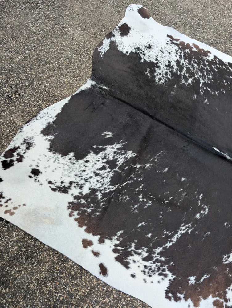 Moon#1 96 x 82 large cowhide rug with black white and natural brown speckles showcasing unique characteristics