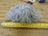 Gray fluffy mushroom sheepskin pom yarn ball with yellow tape