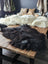 Dark thick-furred natural blacky long wool icelandic sheepskin rug resting on wooden table perfect for cozy decor
