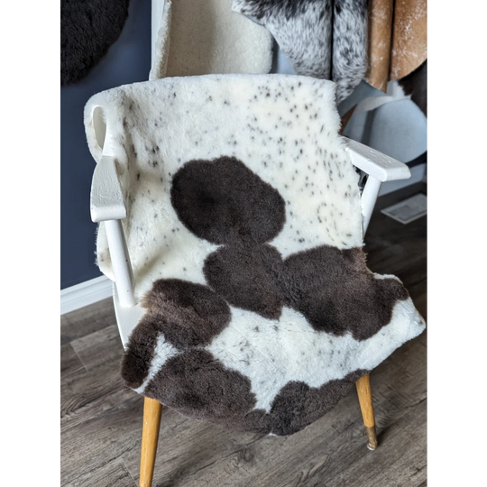 Gorgeous Merino sheepskin cowhide chair cover with brown white patches