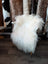 White fluffy sheepskin chair with wooden legs made of natural long wool icelandic sheepskins