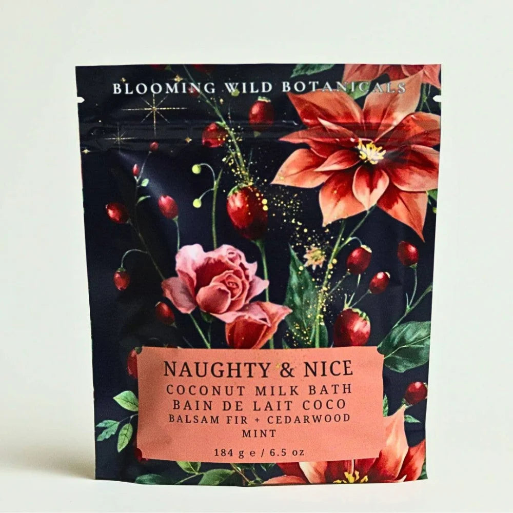Naughty & Nice coconut milk bath salt sachet with floral design, red flowers on black background