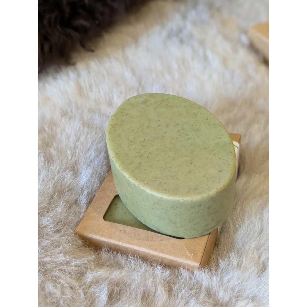 Green speckled nettle tea tree soap bar on gold dish