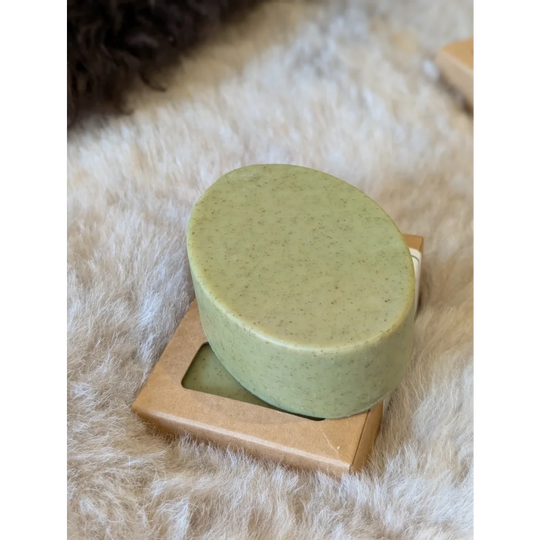 Green speckled nettle tea tree soap bar on gold dish