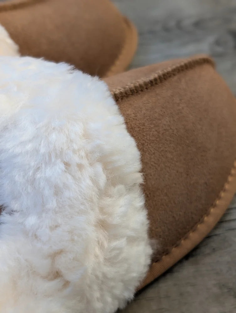 Tan suede slipper with plush white shearling lining offering the ultimate sheepskin slippers comfort