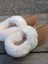 Tan suede moccasin slippers with plush white shearling lining offering ultimate sheepskin comfort at home