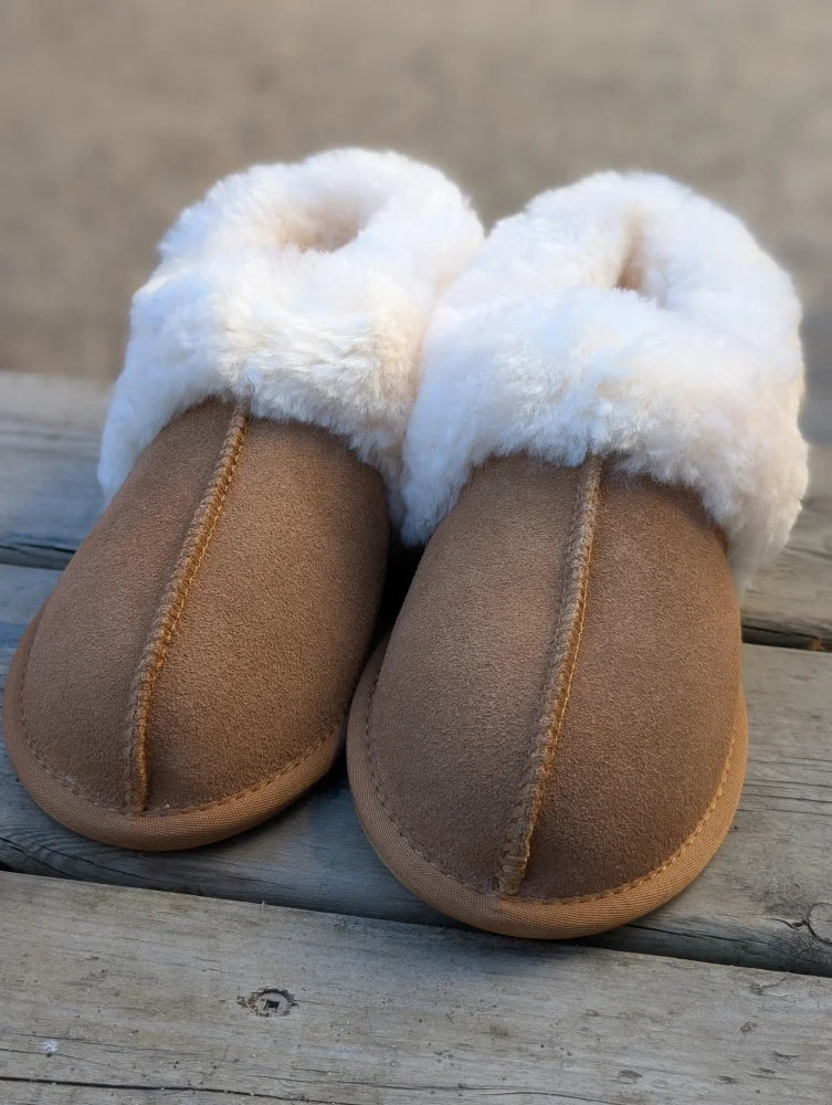 Tan suede slip-on sheepskin slippers with plush white shearling lining for the ultimate sheepskin comfort