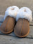 Tan suede slip-on sheepskin slippers with plush white shearling lining for the ultimate sheepskin comfort