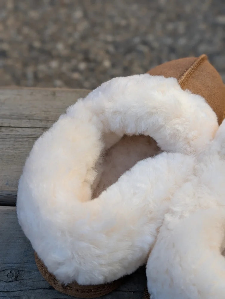 Tan sheepskin slippers with plush white shearling lining offering ultimate sheepskin comfort and warmth