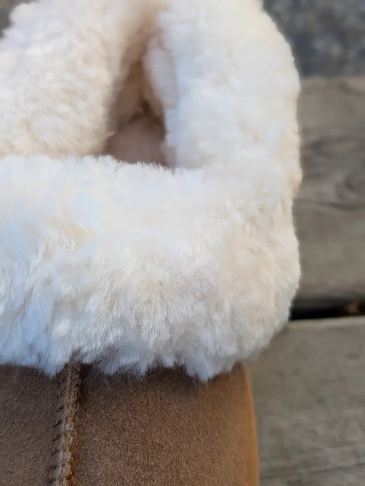 Tan suede slip-on boot with plush white shearling lining perfect for ultimate sheepskin slippers comfort