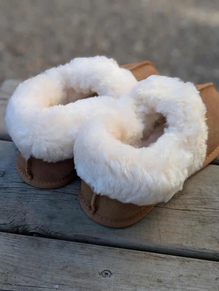 New ultimate sheepskin slippers in tan with plush white fur trim for cozy indoor comfort