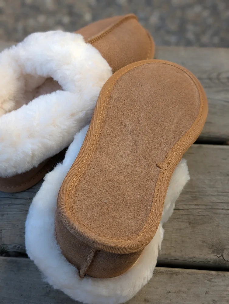 Tan sheepskin slippers with plush white fur trim and suede sole offering the ultimate sheepskin comfort