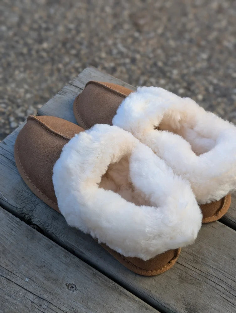 Tan sheepskin slippers with plush white fur trim offering the ultimate sheepskin comfort and warmth