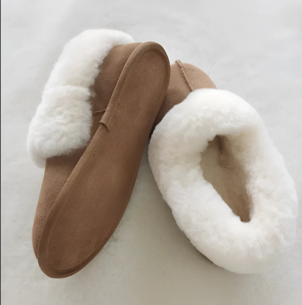 Tan suede moccasins with plush white shearling lining in new ultimate sheepskin slippers for late september and october