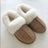 Tan suede slip-on sheepskin slippers with plush white shearling lining perfect for cozy fall wear
