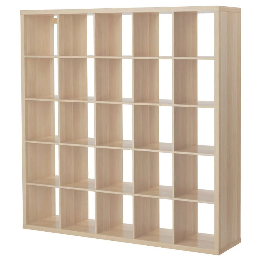 Light-colored wooden shelving with square compartments holding a merino sheepskin cat pad fitting ikea kallax boxes