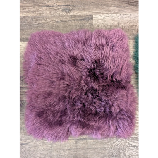 A plush purple sheepskin pet square with soft natural fur pile perfect for ikea storage units and sheepskin squares